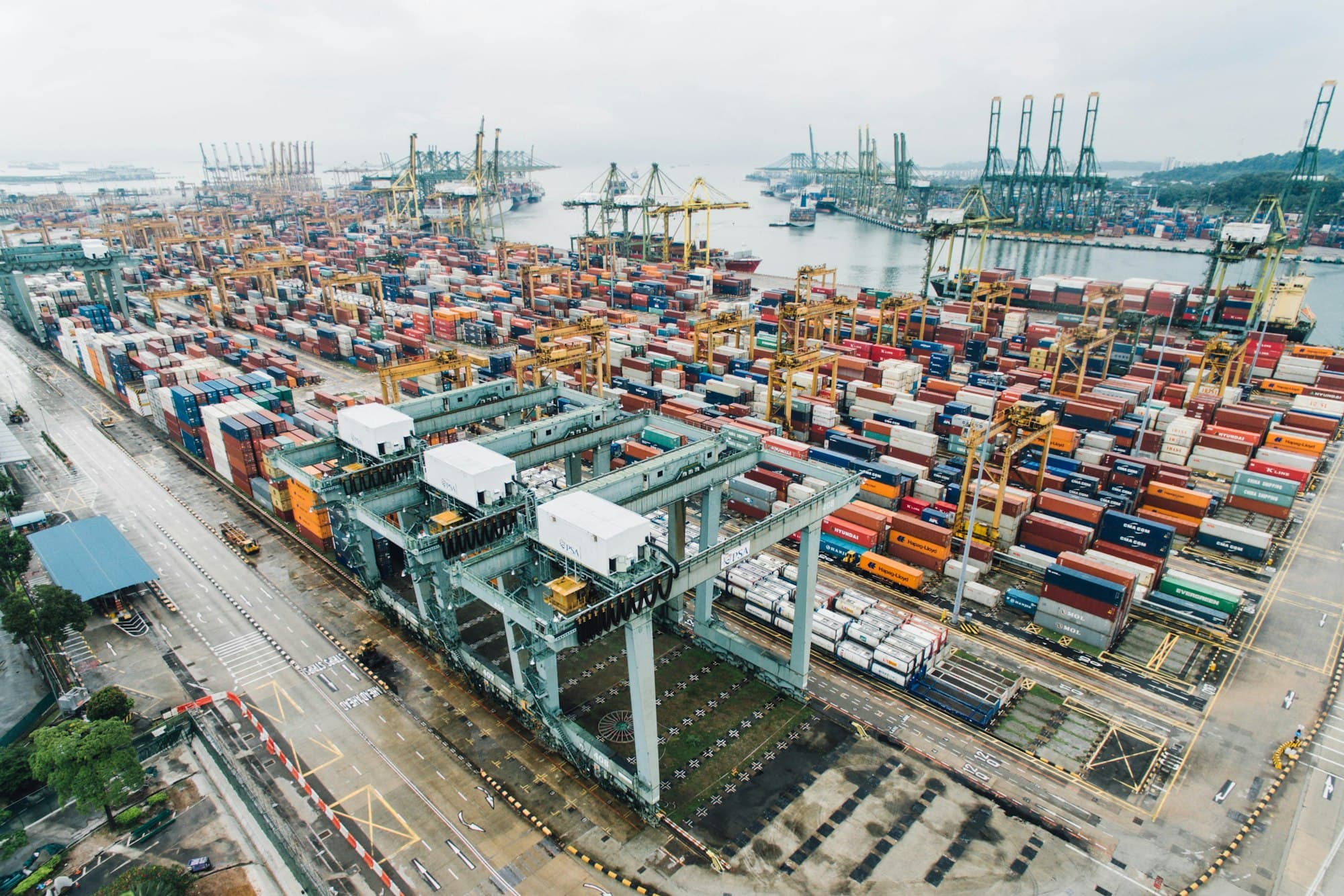 Aerial view of a container port with stacked shipping containers