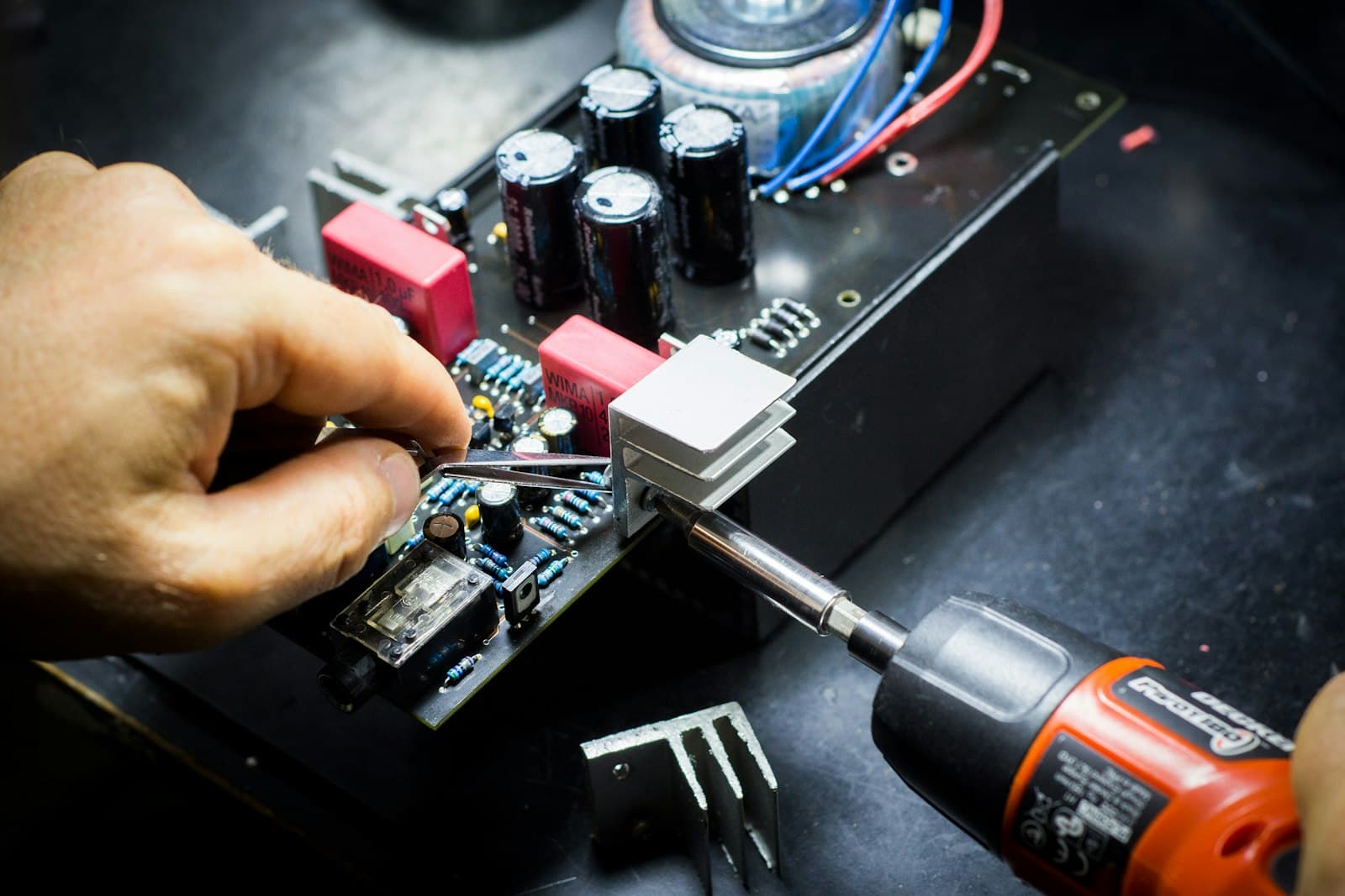 Technician soldering a component on a circuit board