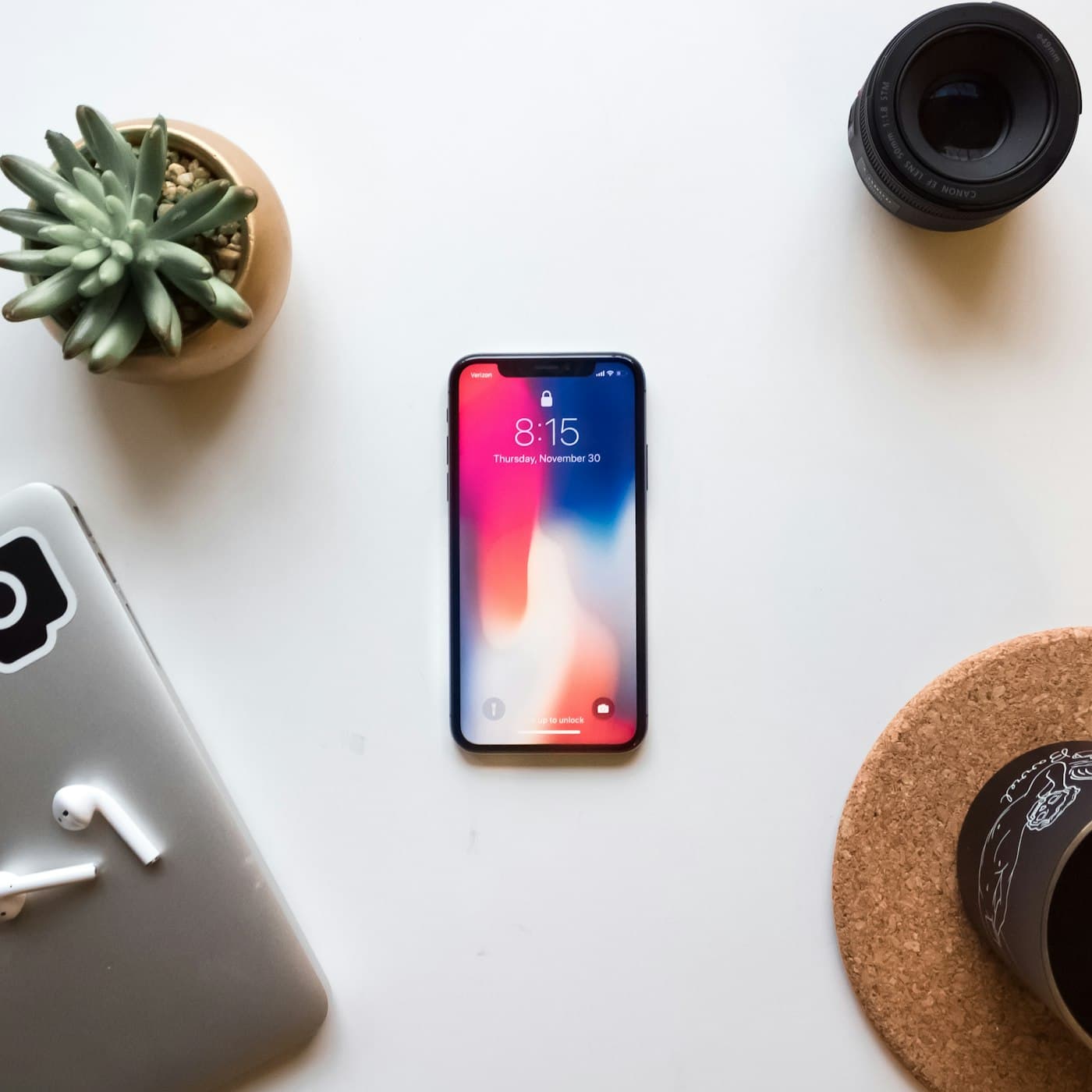 Smartphone lying on a desk beside accessories