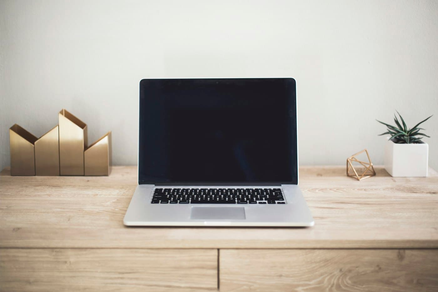 Laptop open on a wooden desk