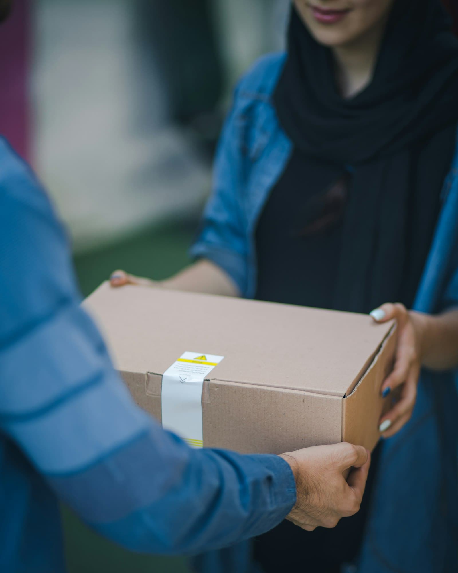 Courier handing over a packed parcel