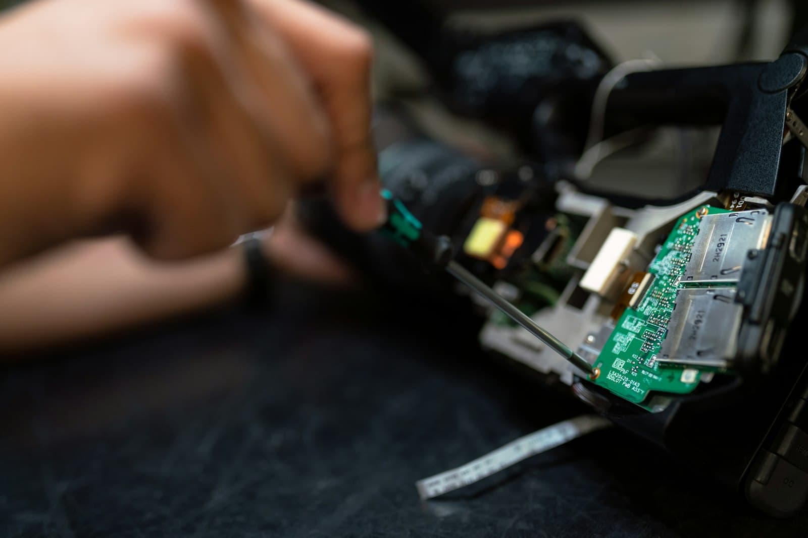 Hands repairing an electronic circuit board